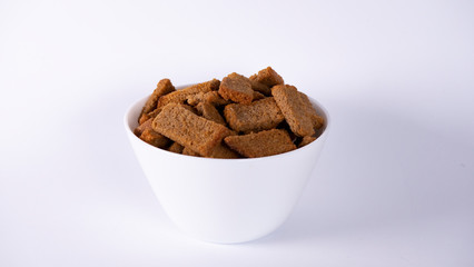 Rusks in a white plate on a white background