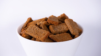 Rusks in a white plate on a white background