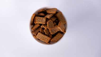 Rusks in a white plate on a white background