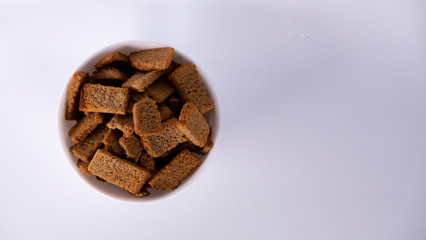 Rusks in a white plate on a white background