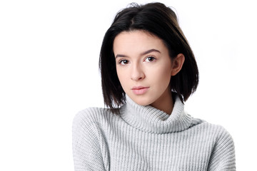 Beautiful young woman smiling against white background.