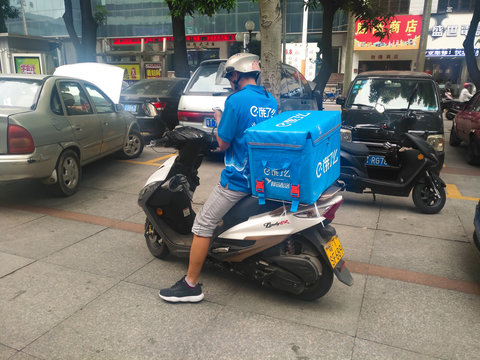 ZHONGSHAN GUANGDONG CHINA - October 23, 2018: E Le Ma Food Delivery People Checking The Mobile Before Delivering Food To The Customer