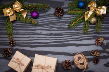 Christmas composition. Fir branches, gifts, fir cones on black background. New year 2020. Flat lay, top view, copy space.