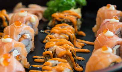 Sushi salmon roll with sauce, Japanese food