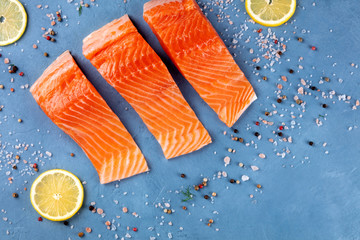 Slices of salmon with lemon, overhead flat lay shot with salt and pepper with a place for text....