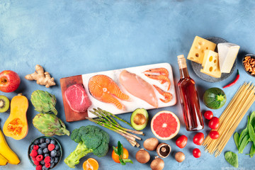 Food, a flat lay composition of many different products, with meat, fish, chicken and shrimps, vegetables and fruits, wine, pasta and cheese, shot from the top with a place for text