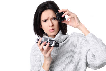 Woman takes images holding photographic camera, isolated on a white