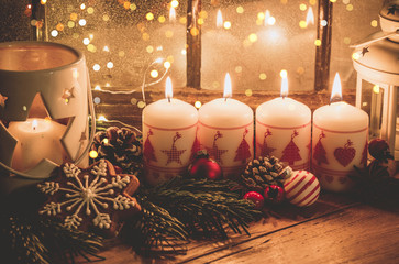 christmas candles and decorations on wooden background