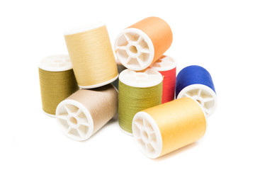 Fototapeta na wymiar Colored spools of cotton thread isolated on white