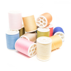 Colored spools of cotton thread isolated on white