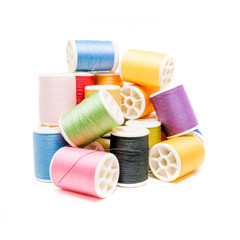 Colored spools of cotton thread isolated on white