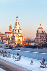 Siberian city of Irkutsk in the Christmas holidays. View of the magnificent architecture of the ancient Epiphany Cathedral in 1741 in the style of Siberian baroque at sunset. Beautiful city landscape - obrazy, fototapety, plakaty