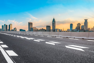 Sunset asphalt road and city skyline in Shanghai