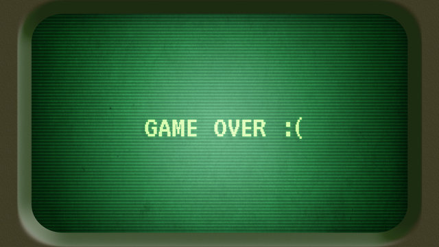 Game over message with sad face on old green computer terminal screen with frame