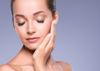 Obraz na płótnie Canvas Beautiful woman face hand manicure nails natural make up healthy skin close up beauty eyes