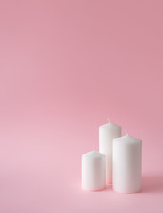 Christmas composition. White Christmas candles on pink background. Happy holidays. new year minimal...