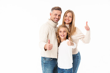 Image of family in winter clothes gesturing thumbs up and smiling