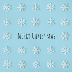Naklejka na ściany i meble Creative snowflakes pattern with bright blue background. Minimal winter flat lay Christmas concept. Merry Christmas