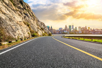 Sunset asphalt road and city skyline in Shanghai