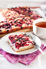 Tasty breakfast. Delicious pie with berries and cottage cheese an a cup of tea