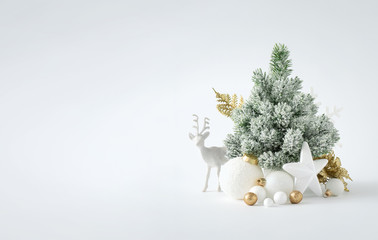 Christmas or New Year layout with white snowy Christmas tree and golden Christmas decoration....