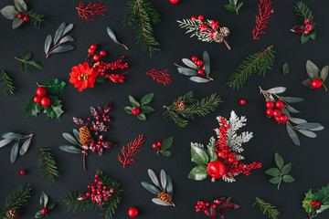 Christmas dark background made of natural winter things. Flat lay pattern.