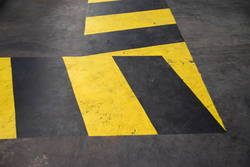 Fototapeta premium Black and yellow colors caution warning sign on the floor for safety