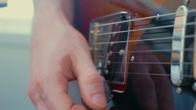 Close up playing electric guitar