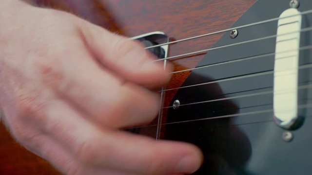 Close up playing electric guitar