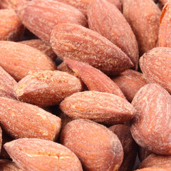 Pile of almonds close-up as background.