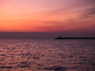 Fototapeta na wymiar Sunrise over the Mediterranean Sea with a view on a pier. Larnaca, Cyprus