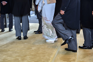 Men wearing the same tail coats at an official ceremony