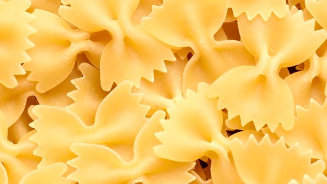 Pile of raw italian farfalle pasta rotating in circle