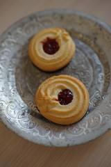 Two cookies with jam in a vintage silver plate.