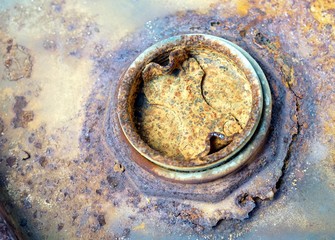 Close up a oxidation rust erosion on a metal cover.