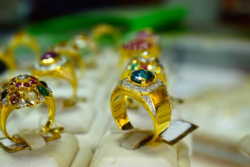  Gold rings decorated with aquamarine and diamonds in a jewelry cabinet
