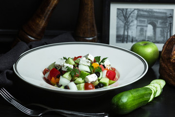 greek salad with olives, tomatoes, cucumbers, onion and parsley