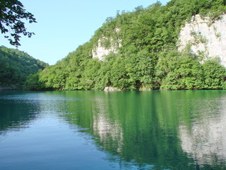 Amazing natural picture of the mirror surface of mountain lakes surrounded by wild, pristine forest.