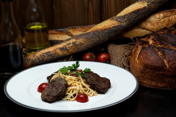 beef cutlet served with spaghetti in cream sauce