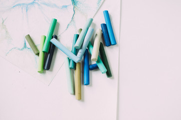pastel crayons on white paper in bulk. isolated