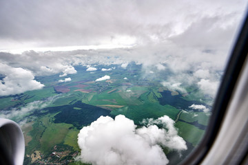 Shooting from the plane. Summer landscape in bad weather