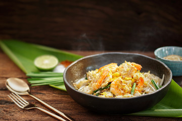 Thai traditional food: Pad Thai, stired noodles with shrimps, egg served with lime, vegetable. Pad Thai on street food, Thailand, Clean food good taste concept.
