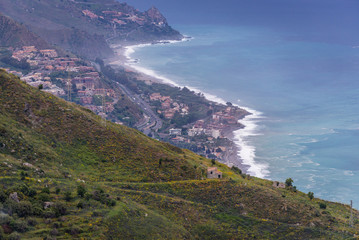 Green hill and Ionian sea shore of Letojanni village - view from Castelmola, small town on Sicily Island, Italy