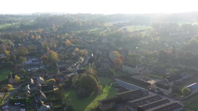 Dolly aerial pull back reveal from St James' church in Longborough, a small village near Moreton-In-Marsh in the Cotswolds Area Of Outstanding Natural Beauty, UK