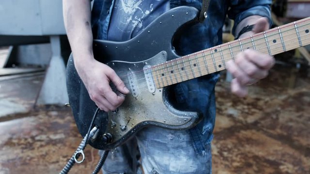 Guy energy finger playing guitar closeup use electro heavy music outdoor 4K.