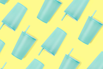 Baby's blue plastc sip cup pattern on yellow background