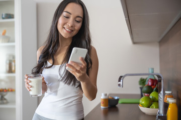 Happy female looking at her mobile device