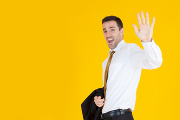Portrait of a handsome adult business man smiling with successful concept on yellow background