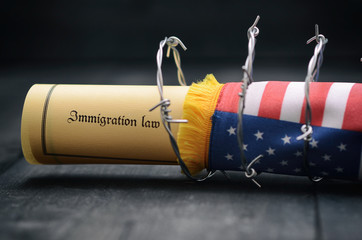 Barbed wire , Immigration Law and flag of United States Of America stock photo