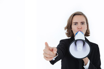 A business beautiful woman in a suit is shouting and pointing her hand forward, shouting at a megaphone on a white background in the concept of business success and inciting unity.